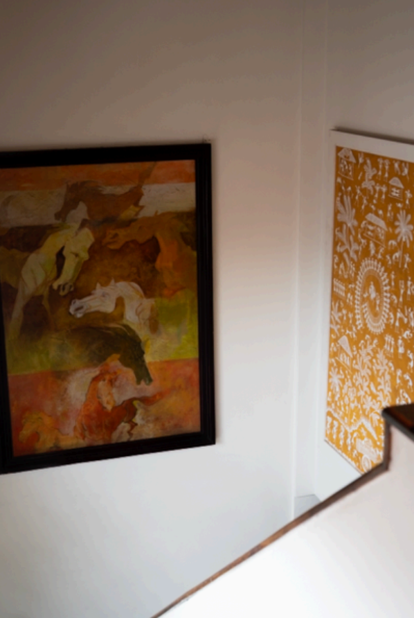 Two framed artworks on a wall, one with animals and the other with geometric patterns.